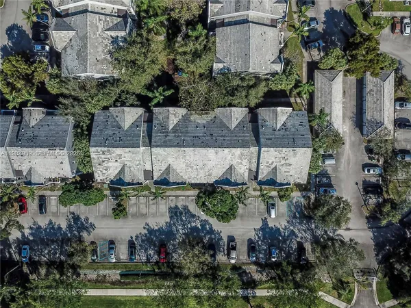 an aerial view of a house with a yard and a fountain