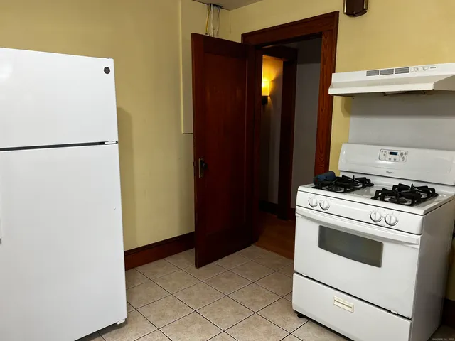 a kitchen with a stove and a refrigerator