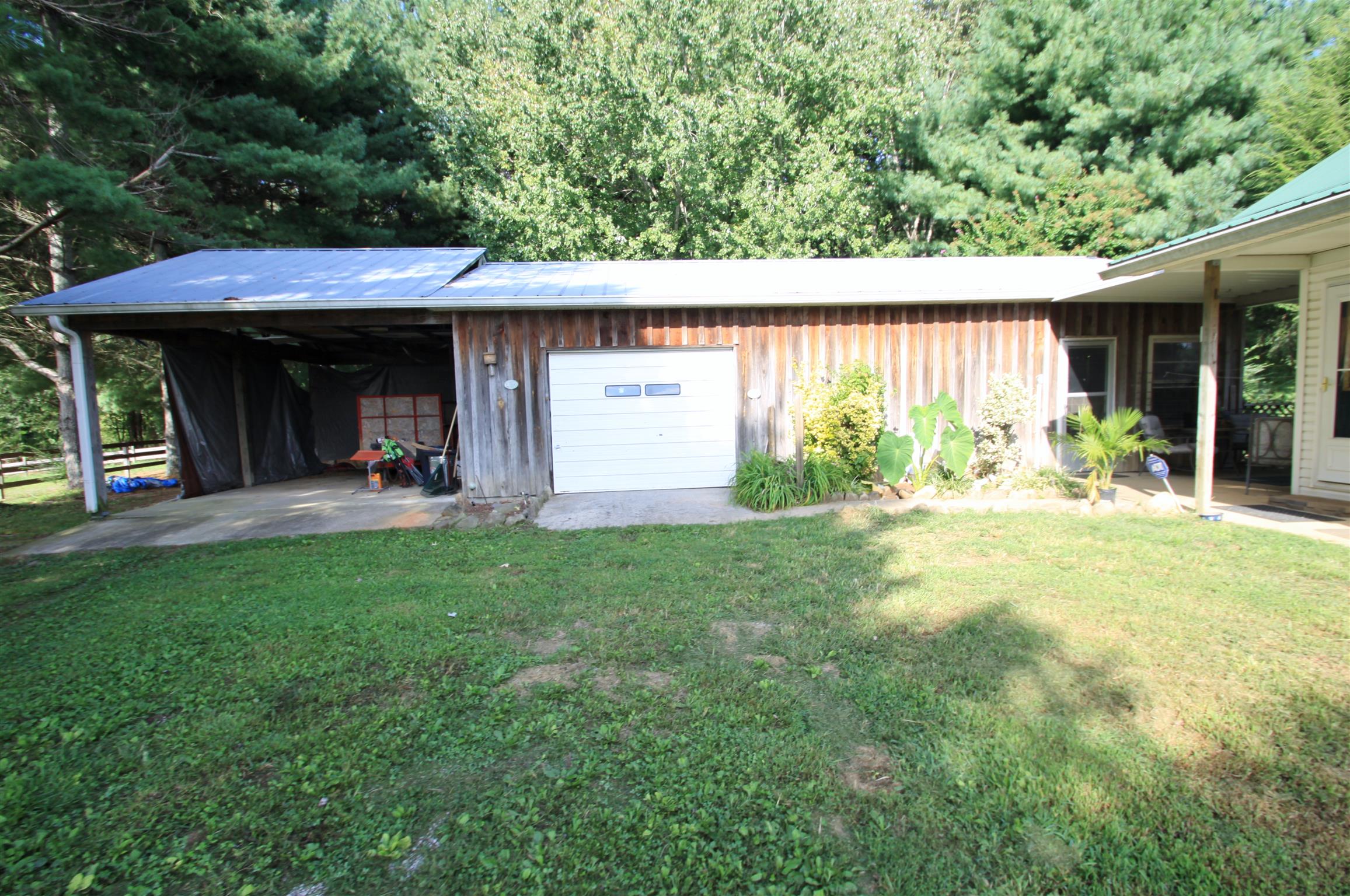 922 Harpo Road Manchester, TN 37355 - Photo 3 of 17 a view of a backyard with table and chairs and a large tree
