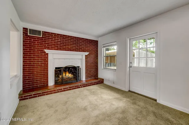 a view of an empty room with a fireplace