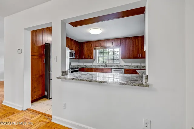 a kitchen with stainless steel appliances granite countertop a refrigerator and a sink