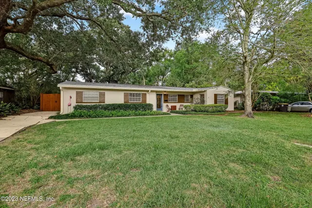 a front view of house with yard and green space