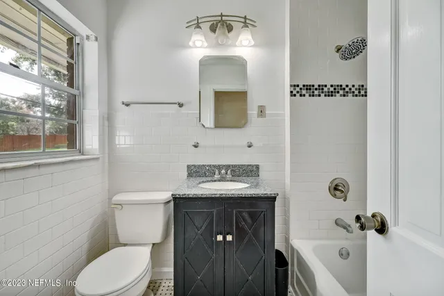 a bathroom with a toilet a sink and mirror