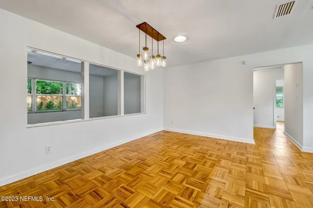 a view of an empty room with glass door