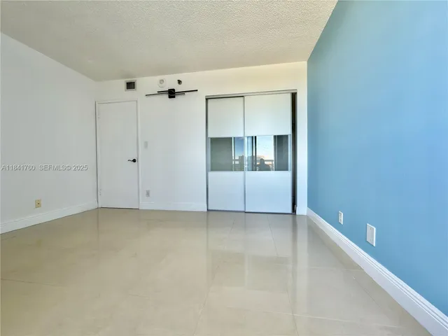a bathroom with a granite countertop toilet a sink and a mirror