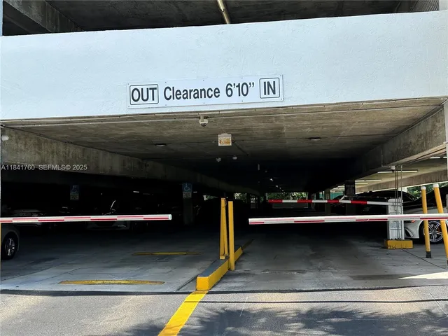 a view of a hallway with wooden floor and cabinet