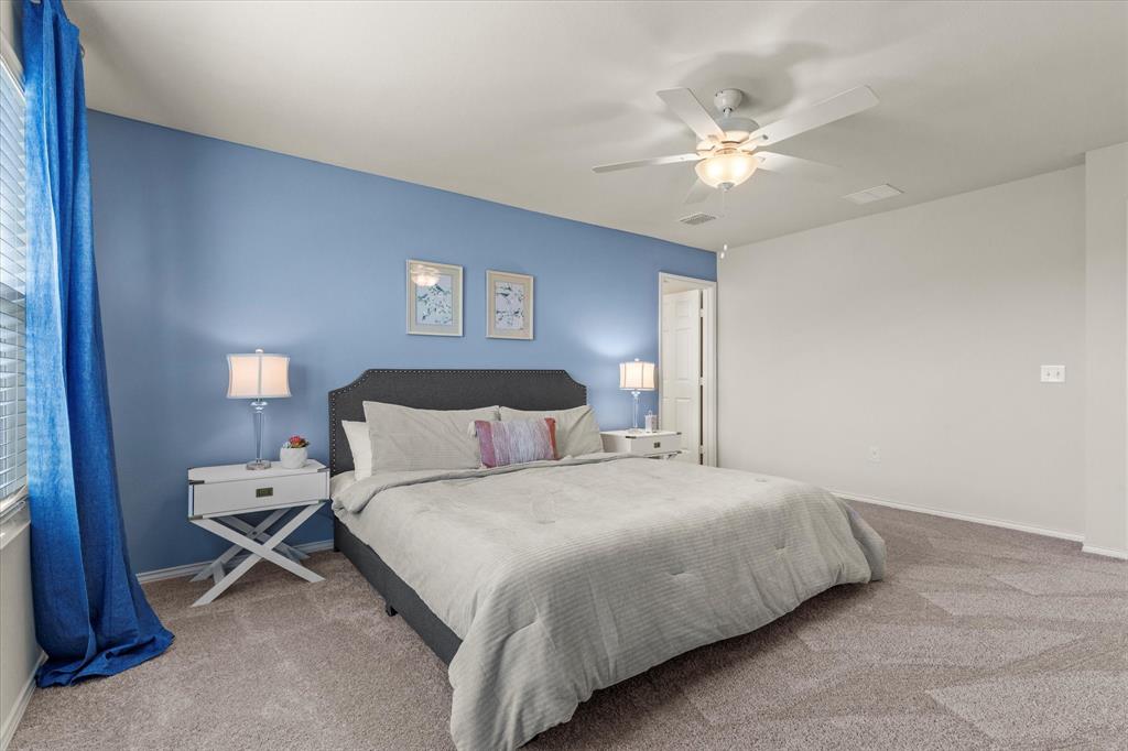 14056 Ilderton Street Pilot Point, TX 76258 - Photo 16 of 34 a bedroom with a bed and a chandelier