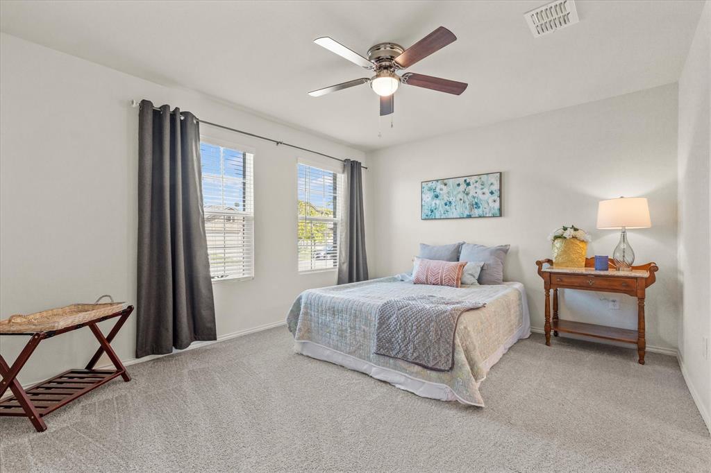 14056 Ilderton Street Pilot Point, TX 76258 - Photo 22 of 34 a bedroom with a bed and a window