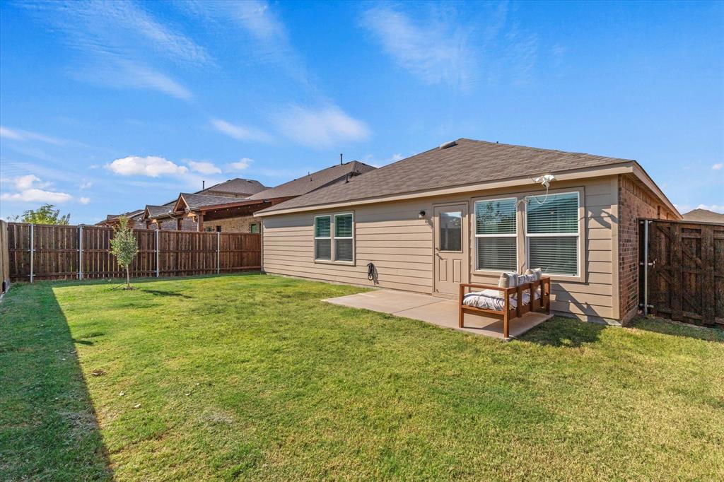 14056 Ilderton Street Pilot Point, TX 76258 - Photo 28 of 34 a backyard of a house with table and chairs