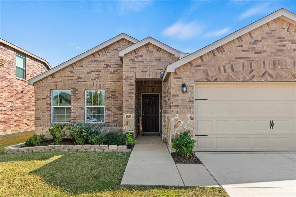 14056 Ilderton Street Pilot Point, TX 76258 - Photo 4 of 34 a front view of a house with garden