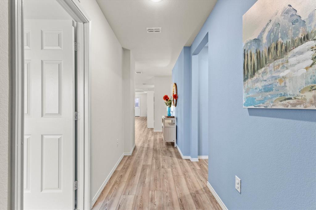 14056 Ilderton Street Pilot Point, TX 76258 - Photo 5 of 34 a view of a hallway with wooden floor and staircase