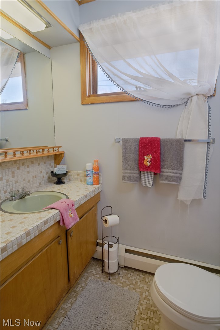 4061 Marks Rootstown, OH 44272 - Photo 15 of 25 Bathroom featuring toilet, backsplash, tile floors, and oversized vanity