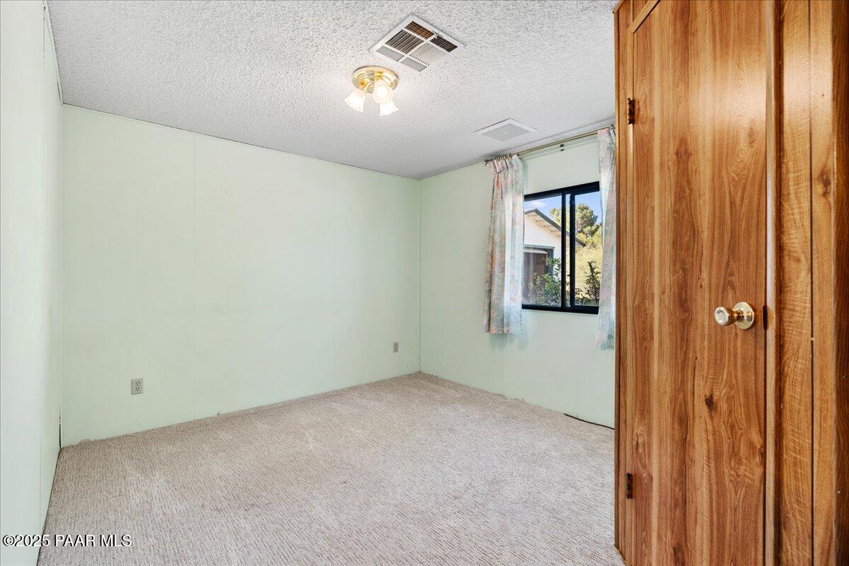14012 Holly Road Mayer, AZ 86333 - Photo 16 of 28 an empty room with windows and closet