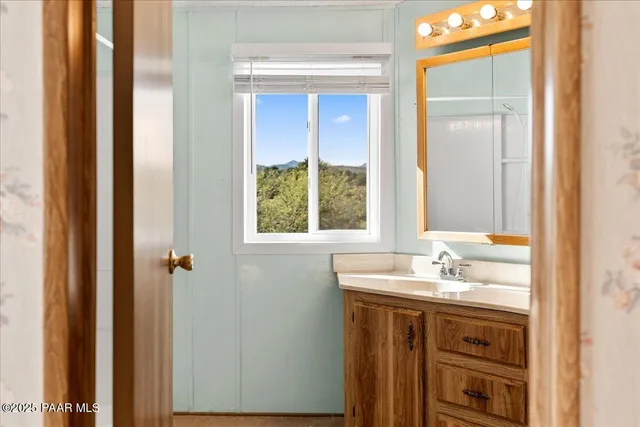 a bathroom with a sink and a window