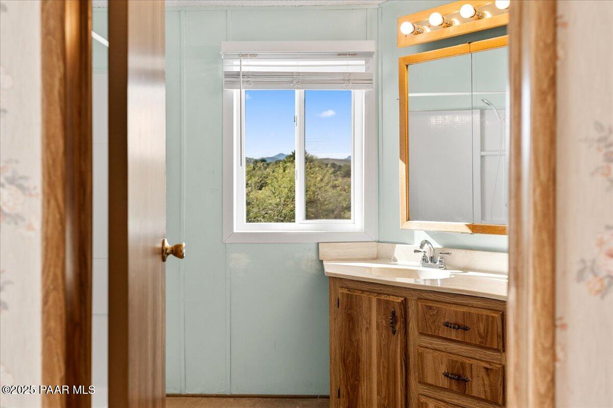 14012 Holly Road Mayer, AZ 86333 - Photo 20 of 28 a bathroom with a sink and a window