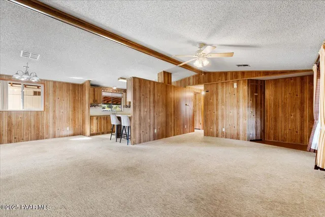 a view of empty room with furniture and refrigerator