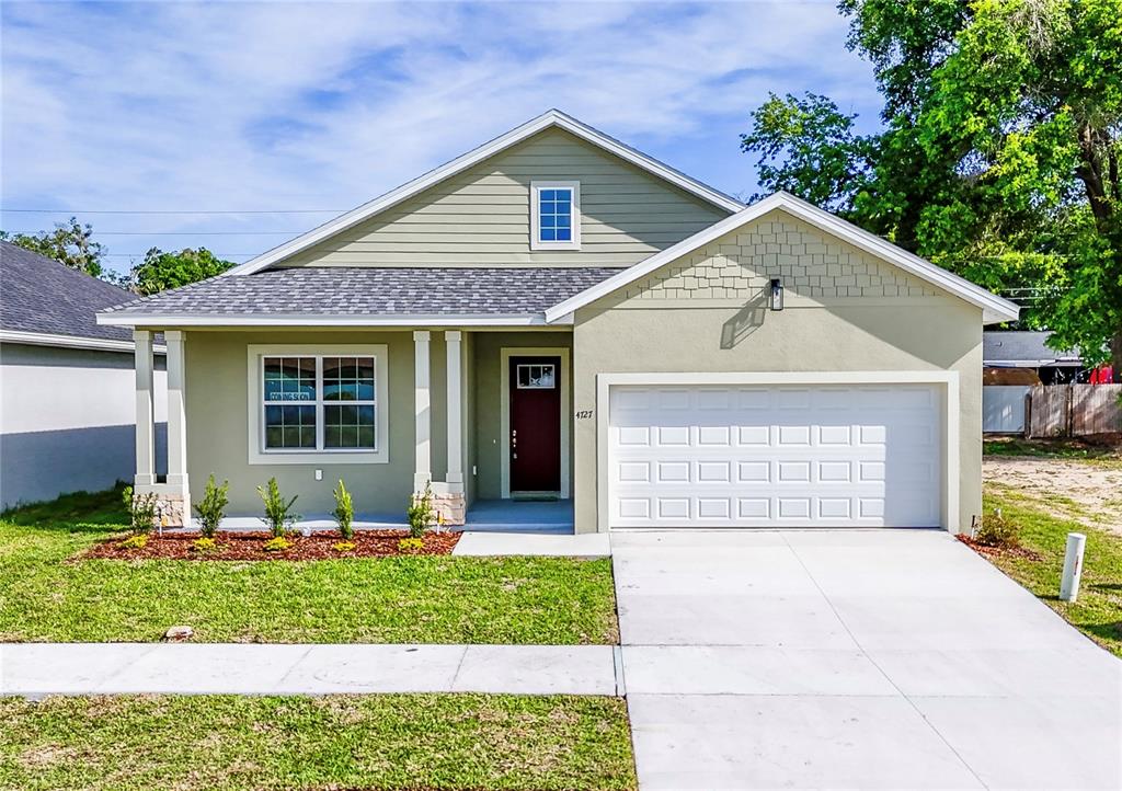 4727 Southeast 25th Loop Ocala, FL 34480 - Photo 1 of 29 a front view of a house with a yard and porch