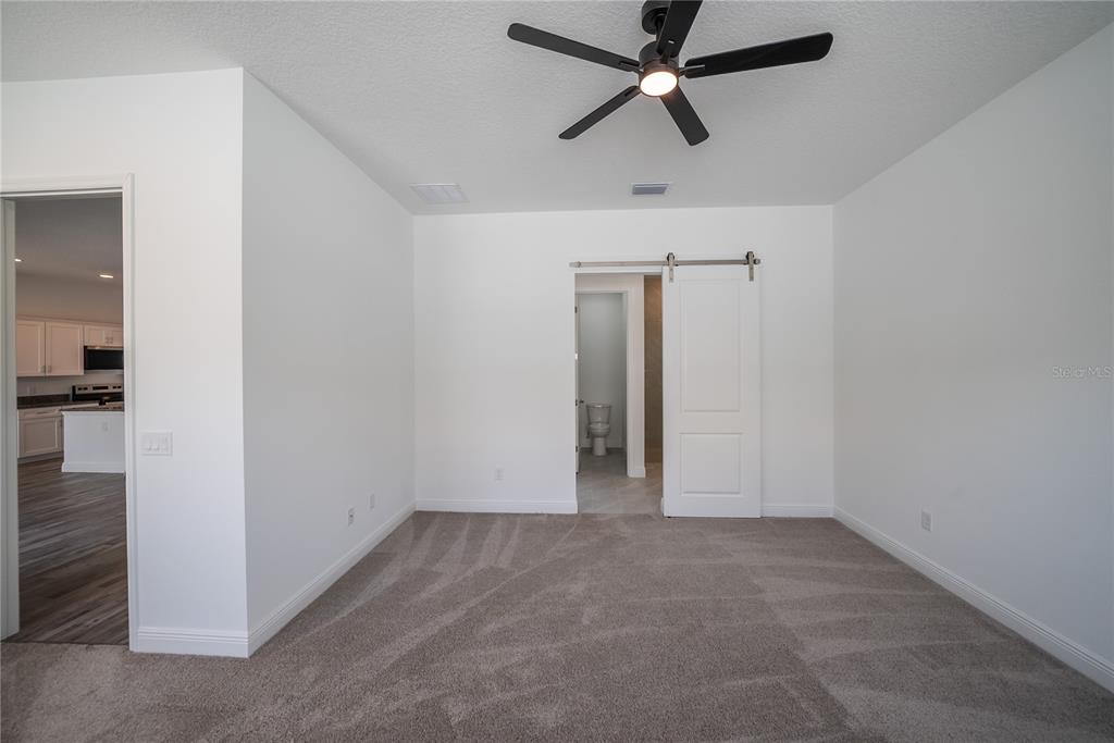 4727 Southeast 25th Loop Ocala, FL 34480 - Photo 11 of 29 an empty room with closet and a ceiling fan