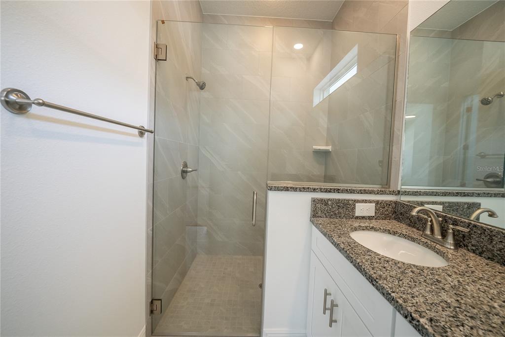 4727 Southeast 25th Loop Ocala, FL 34480 - Photo 12 of 29 a bathroom with a granite countertop sink and a mirror