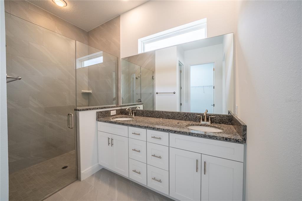 4727 Southeast 25th Loop Ocala, FL 34480 - Photo 13 of 29 a bathroom with a granite countertop sink double and mirror