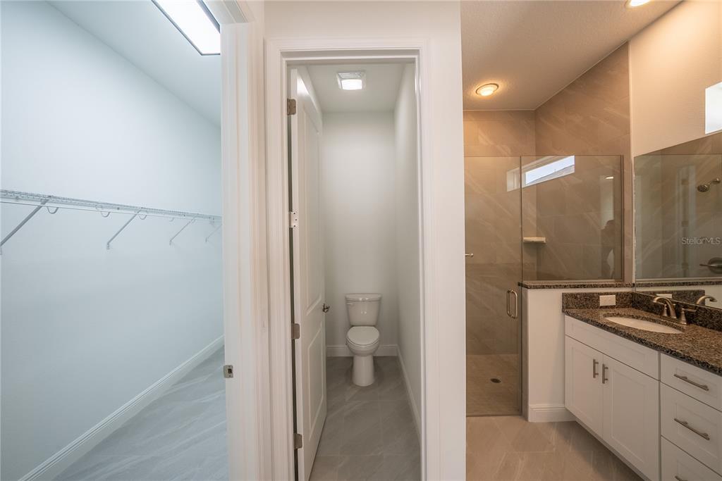 4727 Southeast 25th Loop Ocala, FL 34480 - Photo 15 of 29 a bathroom with a granite countertop sink and a mirror