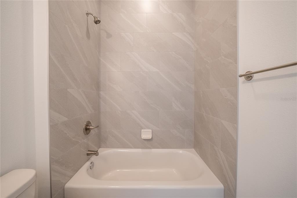 4727 Southeast 25th Loop Ocala, FL 34480 - Photo 19 of 29 a white bath tub sitting next to a white toilet