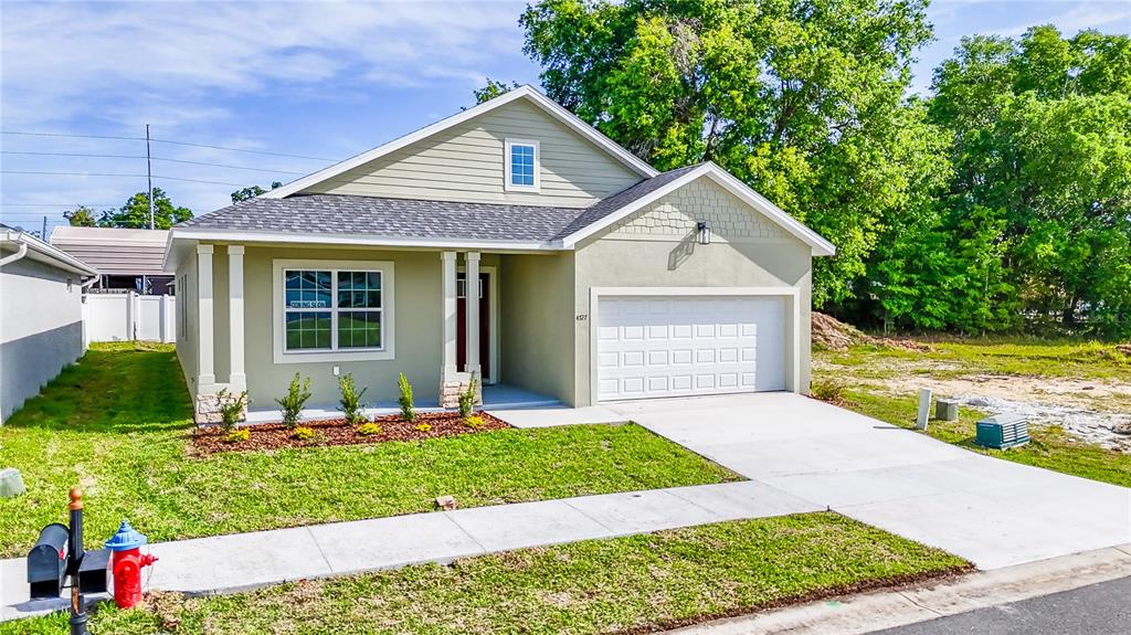 4727 Southeast 25th Loop Ocala, FL 34480 - Photo 28 of 29 a front view of a house with a yard and garage