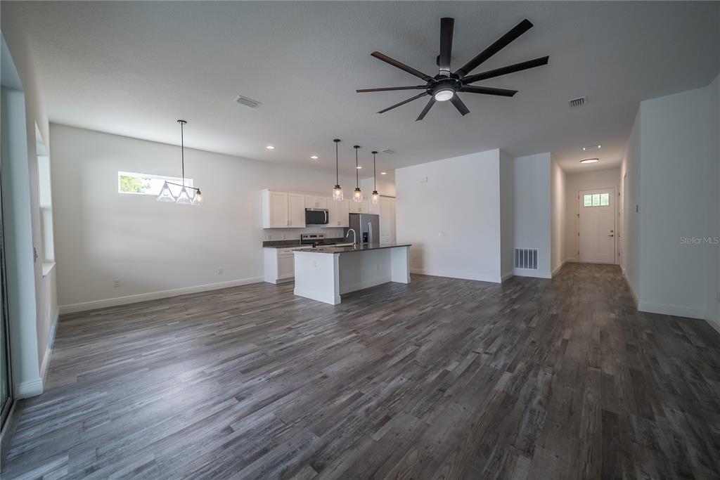 4727 Southeast 25th Loop Ocala, FL 34480 - Photo 6 of 29 a view of a kitchen with a sink and a refrigerator