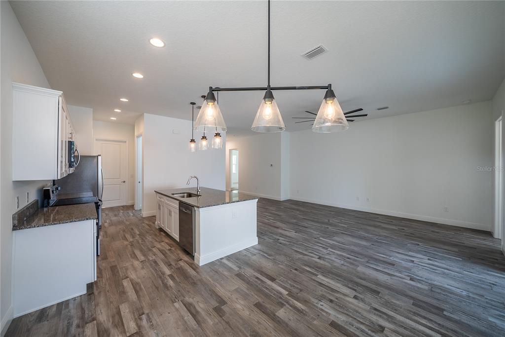 4727 Southeast 25th Loop Ocala, FL 34480 - Photo 8 of 29 a kitchen with stainless steel appliances kitchen island a large island in the center