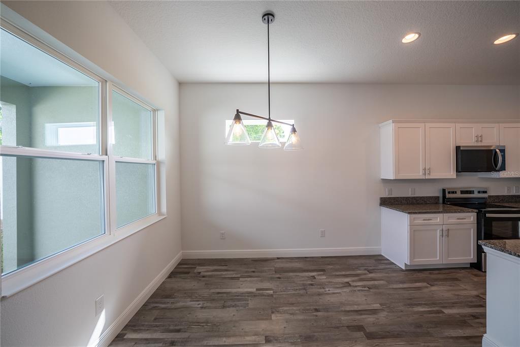 4727 Southeast 25th Loop Ocala, FL 34480 - Photo 9 of 29 a kitchen with microwave and stove