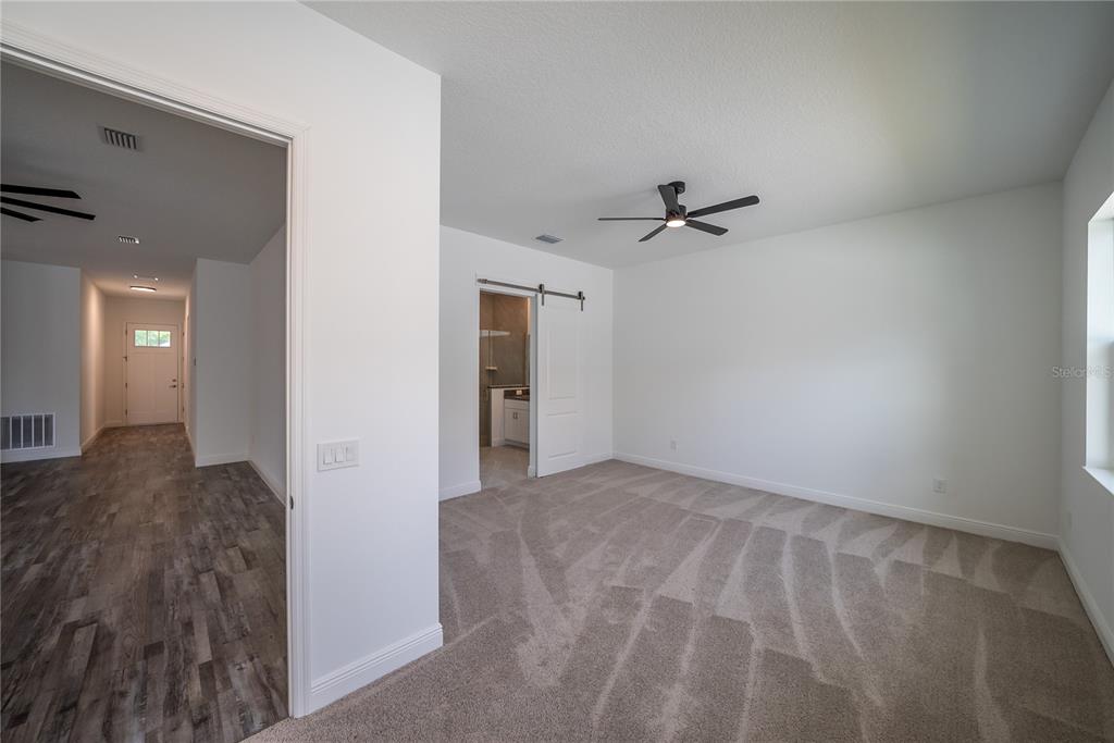 4727 Southeast 25th Loop Ocala, FL 34480 - Photo 10 of 29 a view of a livingroom with a ceiling fan and wooden floor