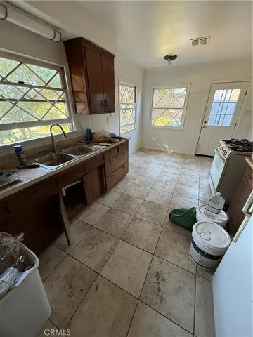 a kitchen with a sink and a stove top oven