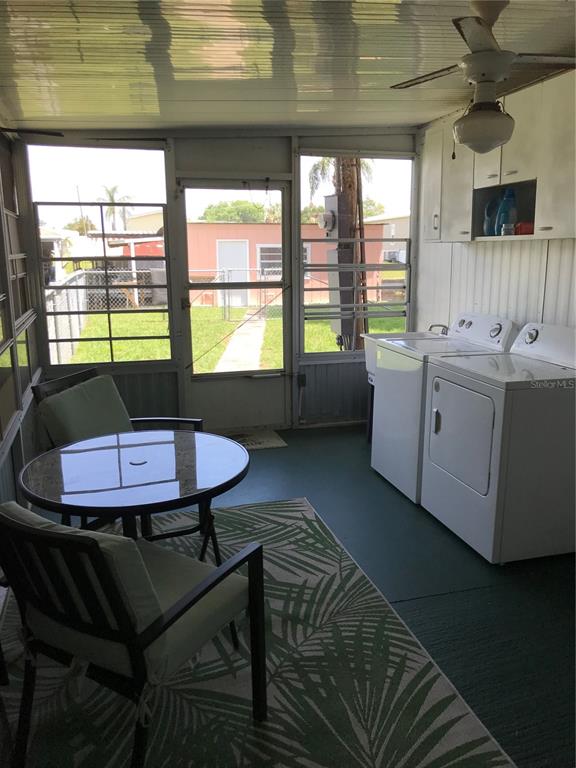 1091 Lemon Street Okeechobee, FL 34974 - Photo 12 of 19 a kitchen with a table chairs and a stove