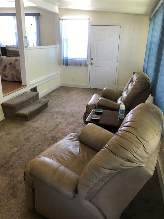1091 Lemon Street Okeechobee, FL 34974 - Photo 6 of 19 a living room with furniture and a window