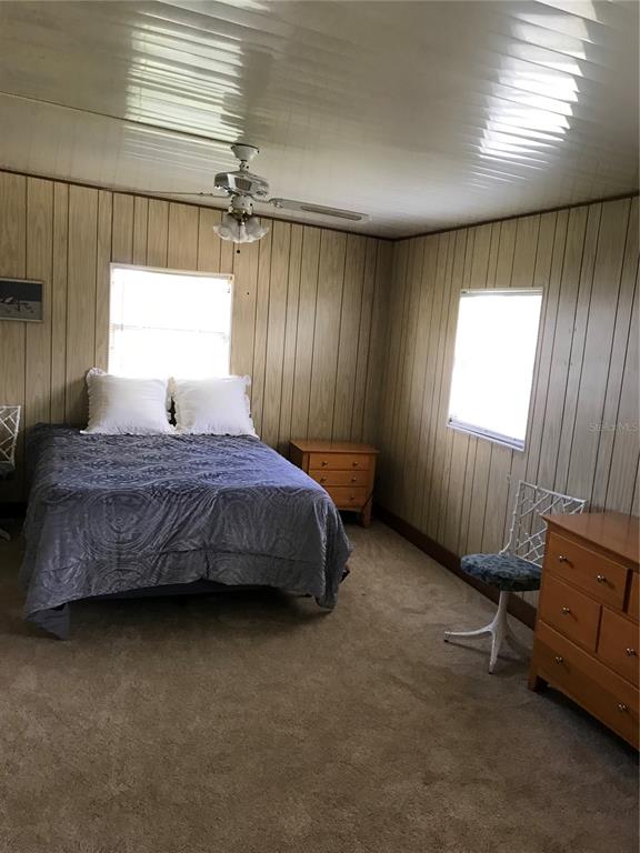 1091 Lemon Street Okeechobee, FL 34974 - Photo 7 of 19 a bedroom with a bed and a window