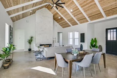 a view of a dining room with furniture and a potted plant