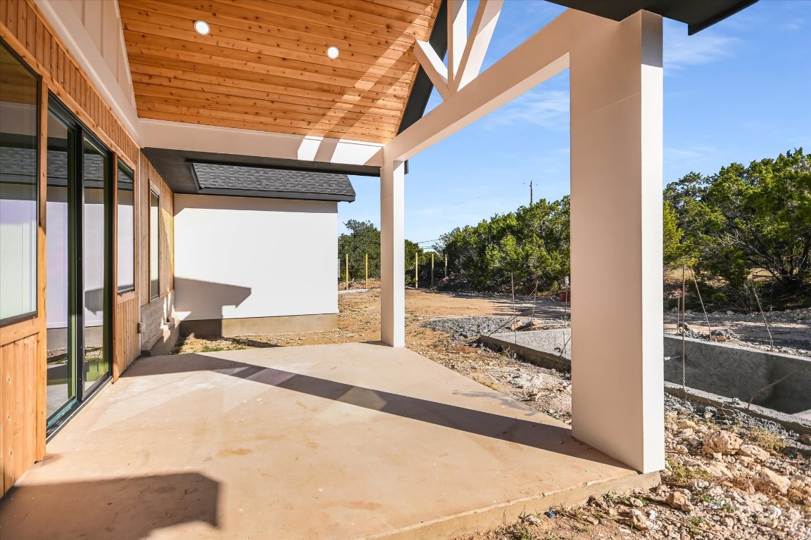 54 War Bonnet Wimberley, TX 78676 - Photo 26 of 32 a view of a porch with a floor to ceiling window and tree
