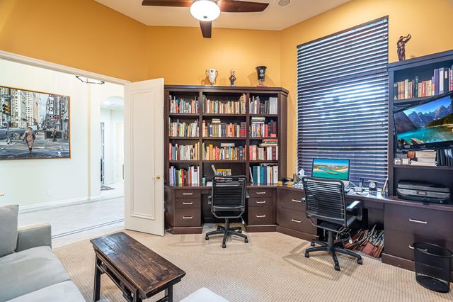 a work room with furniture and a bookshelf