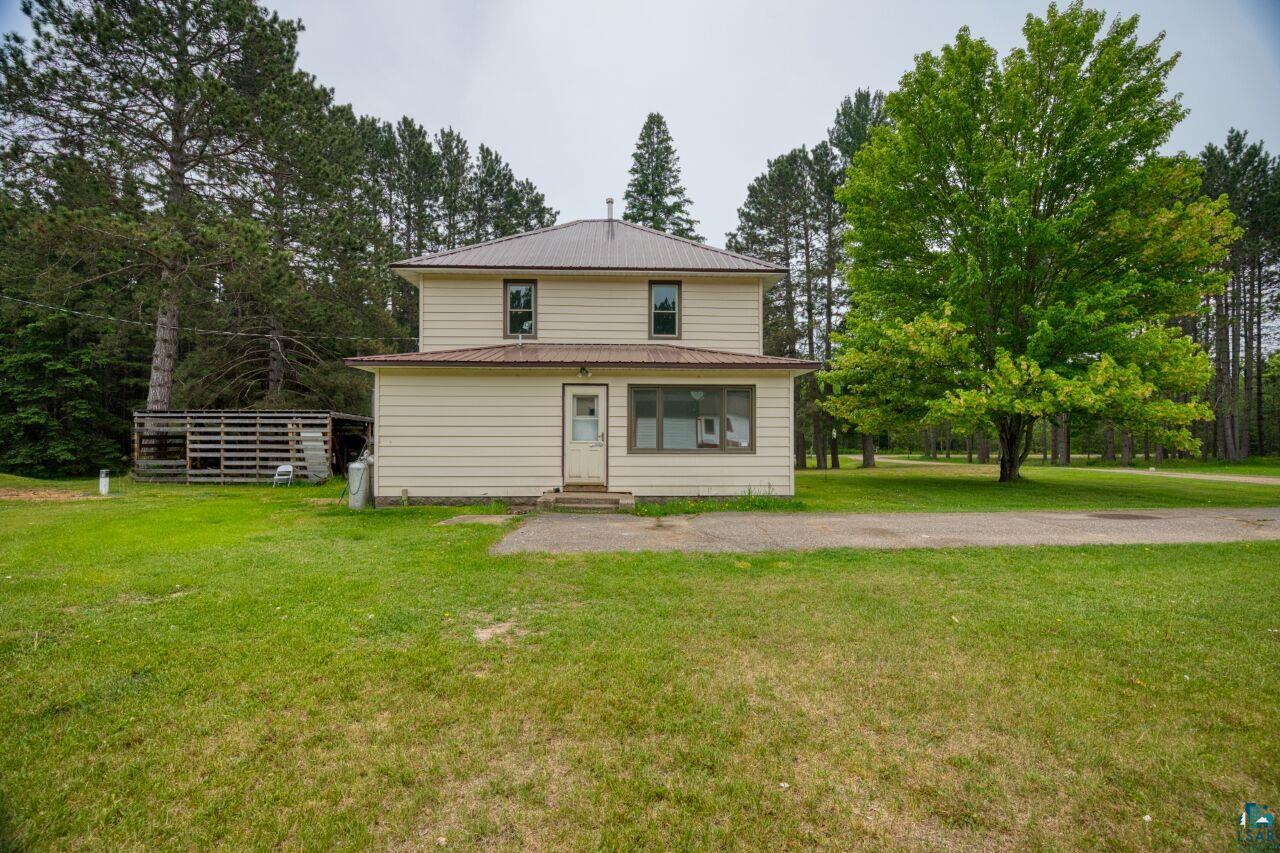 4755 Judd Road Gilbert, MN 55741 - Photo 39 of 50 Rear view of house with entry steps, a yard, and metal roof