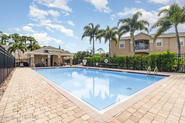 a view of house with swimming pool outdoor seating