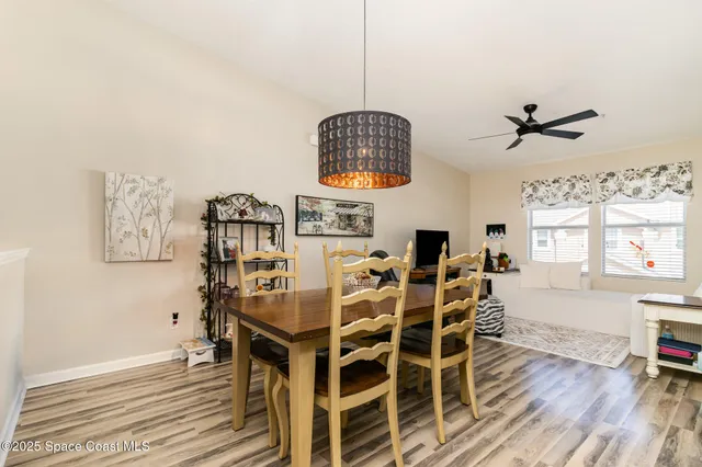 a dining room with furniture and wooden floor