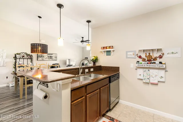 a kitchen with a sink a stove and a wooden floor