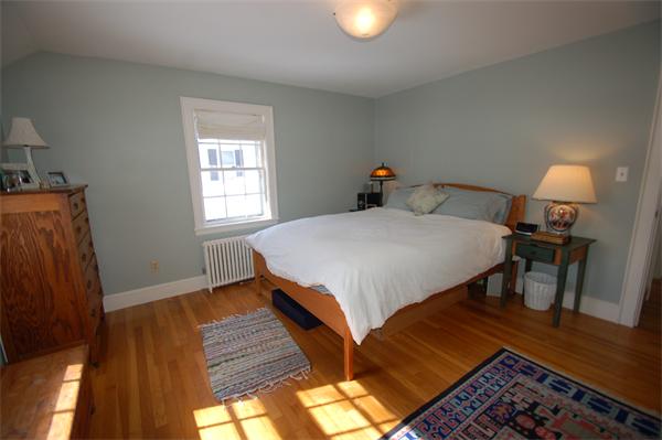 5 Garrison Road Wellesley, MA 02482 - Photo 12 of 19 a bedroom with a bed and wooden floor