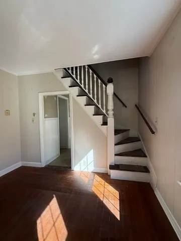 a view of entryway and hall with wooden floor