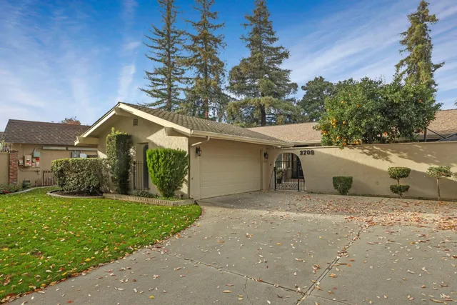 a view of a house with a yard and garage