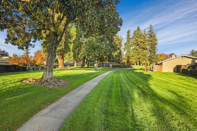 a backyard of a house with table and chairs