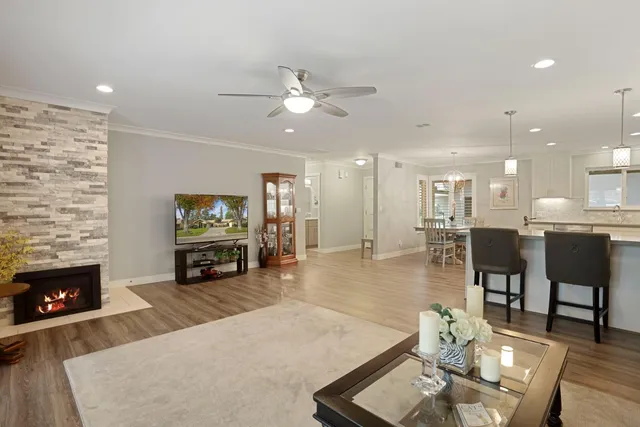 a living room with fireplace furniture and a flat screen tv