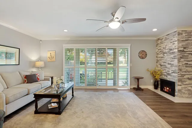 a kitchen with a dining table chairs wooden floor appliances and cabinets