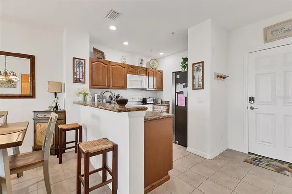 a kitchen with stainless steel appliances granite countertop a refrigerator and a stove top oven
