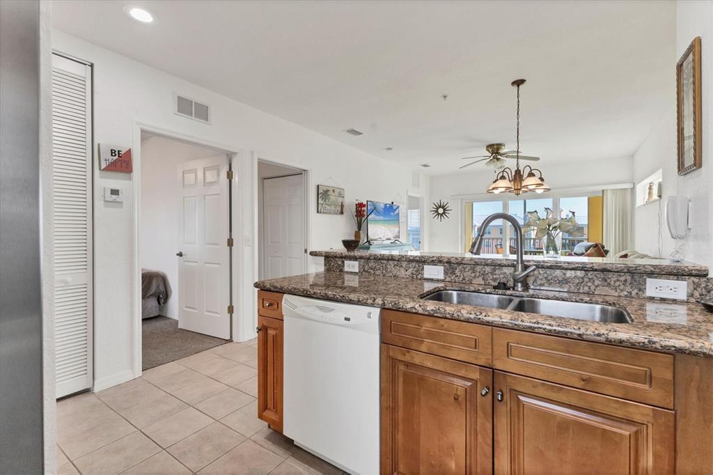 8411 Placida Road, Unit 404 Placida, FL 33946 - Photo 15 of 54 a kitchen with stainless steel appliances granite countertop a sink and a refrigerator